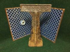 A cast iron Cables post with two antique cast iron grate covers
