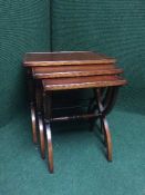 A nest of three mahogany tables