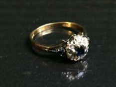 An 18ct gold sapphire and diamond cluster ring