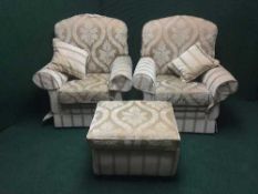 A three piece lounge suite in a gold fabric and footstool
