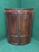 A Georgian inlaid mahogany hanging corner cabinet