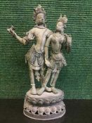 An antique Tibetan bronze figure depicting Buddha with four arms by a lady,