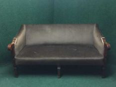 A Victorian inlaid mahogany framed settee upholstered in an olive fabric