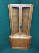 A mid 20th century teak Turnidge corner display cabinet
