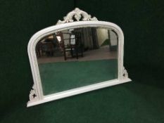 A while framed over mantel mirror