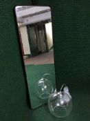 A contemporary framed hall mirror together with a light fitting