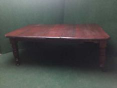 A Victorian mahogany wind out dining table