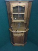 A pine corner display cabinet