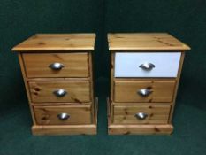 A pair of pine three drawer bedside chests