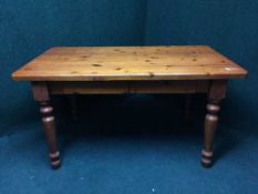 A pine kitchen table fitted two drawers