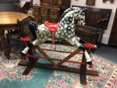 A mid 20th century painted wooden rocking horse,