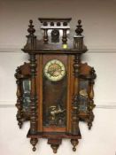 A late Victorian walnut wall clock with mirrored panels