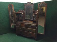 A Victorian walnut dressing table with triple mirror,