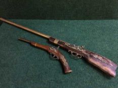 A replica rifle and flint lock pistol