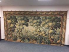 A good quality tapestry wall hanging depicting a forest glade,