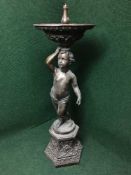 A bronze fountain modelled as a cherub on plinth,