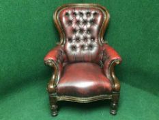 A red button leather Chesterfield style salon armchair
