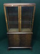 A walnut double door bookcase on claw and ball feet