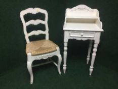 A painted pine telephone table fitted with a drawer together with a pine rush seated ladder backed