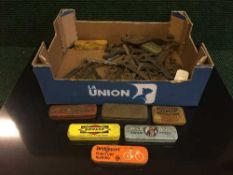 A box of a collection of vintage cycle tools and puncture repair kits