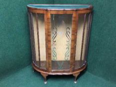 A walnut d-shaped display cabinet