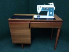 A Touch and Sew electric sewing machine in teak table