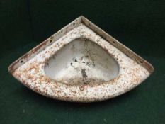 A cast iron corner sink