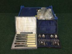 A box of cased and loose stainless steel cutlery