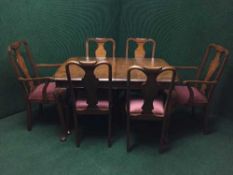 An eight piece walnut dining room suite