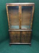 A walnut double door bookcase on claw and ball feet