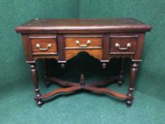 A reproduction mahogany hall table fitted with three drawers