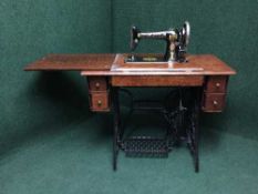 A Singer treadle sewing machine in oak table