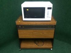 A Panasonic microwave and an Ecko hostess trolley