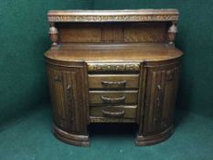 A heavily carved oak buffet backed sideboard