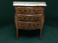 A continental walnut serpentine three drawer chest,