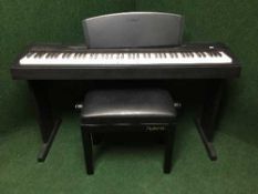 A Yamaha P-60 electronic piano with lead and a Roland adjustable piano stool
