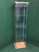 A contemporary narrow glass display cabinet