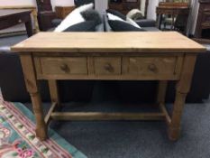 A reclaimed pine three drawer pine side table,