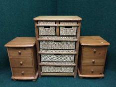 A pine and wicker five drawer chest together with a pair of pine three drawer bedside chests