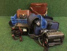 A basket of Sony handi-cam, pair of cased Carl Zeiss Jena binoculars,