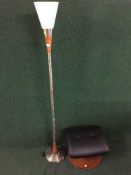 An up lighter and leather footstool on circular base