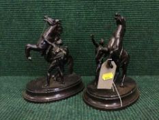 A pair of cast metal figures of horses