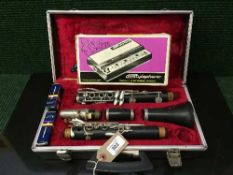 A cased Boosey & Hawkes clarinet in case and a Stylophone