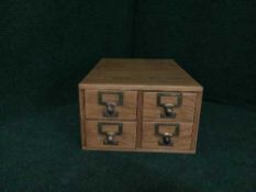 An early 20th century four drawer index chest