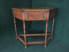 A shaped oak hall table fitted a drawer