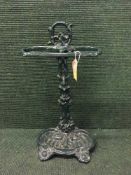 A cast iron stick stand together with three walking sticks