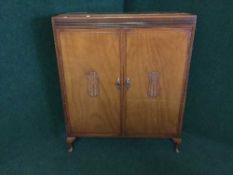 A walnut linen cabinet