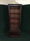 A set of early 20th century open bookshelves fitted a cupboard below