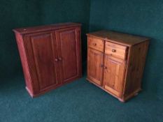A pine double door cupboard and a stained pine cabinet