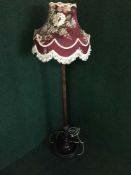A carved mahogany standard lamp and shade